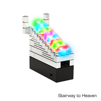 The Power Blox™ Standard Set - E-Blox® Student Set by E-Blox features a "Stairway to Heaven" model with a staircase made of white and transparent bricks. Each step is illuminated with different colored LED lights, creating a vibrant and luminous path that ascends upward. Utilizing patented technology, the base houses intricate 3D circuits for enhanced lighting effects.