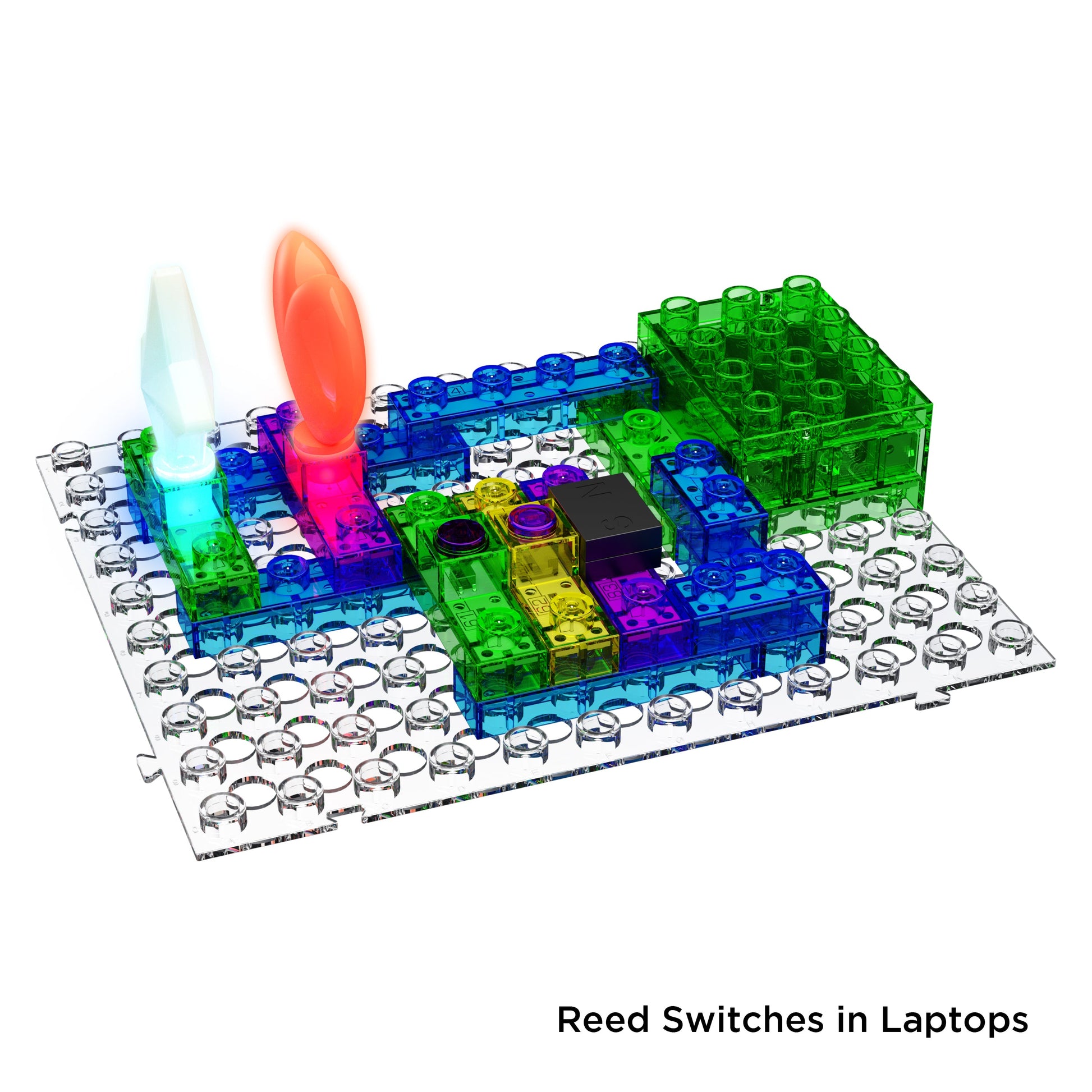 The Circuit Blox™ 395 Project Classroom Set from E-Blox features a vibrant electronic circuit board with interconnected translucent pieces in green, blue, purple, and yellow that demonstrates advanced STEM concepts. Two lights, one red and one white, are illuminated. The board includes a grid of pegs and is labeled "Reed Switches in Laptops" at the bottom right.