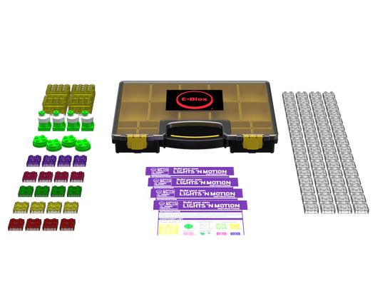 A top-down view of the Circuit Blox™ Lights 'n Motion- Classroom Set by E-Blox. The set includes various green, red, and purple LED blocks, three instruction sheets, four black-and-white grids, and a yellow carrying case with a black handle—perfect for educational play within the STEM curriculum.