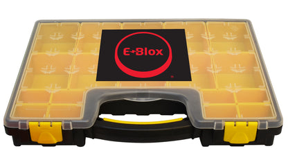 A transparent plastic storage case with multiple small compartments. The front of the case showcases the "E-Blox" logo, featuring text in a black box with a red circle around it. Designed for lesson-based curriculum use, the Lite Blox Classroom Set - E-Blox® Building Blocks case has a black handle with yellow latches to secure your materials.