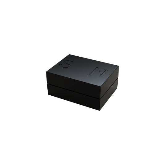 A sleek, black rectangular box with the embossed letters "E-Blox" on its top surface. The Circuit Blox™ - Magnet - E-Blox® box has a glossy finish and appears to be made of a sturdy material, possibly incorporating a magnet for secure closure. The design is minimalist and modern.