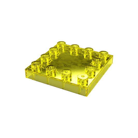 A close-up of an E-Blox Power Amplifier Block for Circuit Builder, featuring a yellow translucent plastic, a flat square shape, and 12 studs on top. The shiny block is displayed against a plain white background.