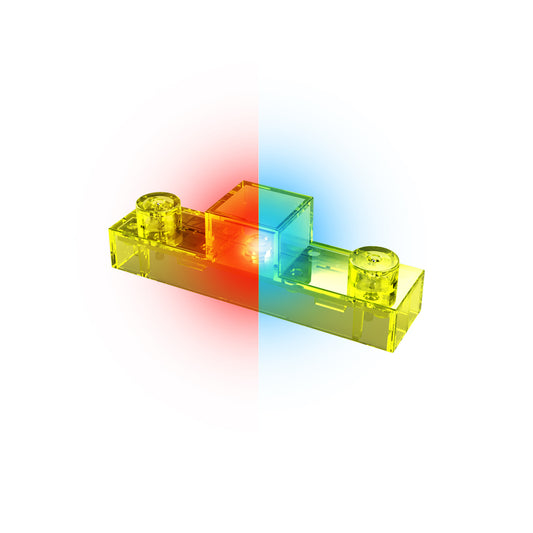 A see-through yellow plastic brick from the Circuit Blox™ - Bi-Directional LED - E-Blox® set, featuring round stud connections on top. The brick glows with a gradient light effect that transitions from red on the left side to blue on the right side against a white background, creating an enchanting LED display for E-Blox.