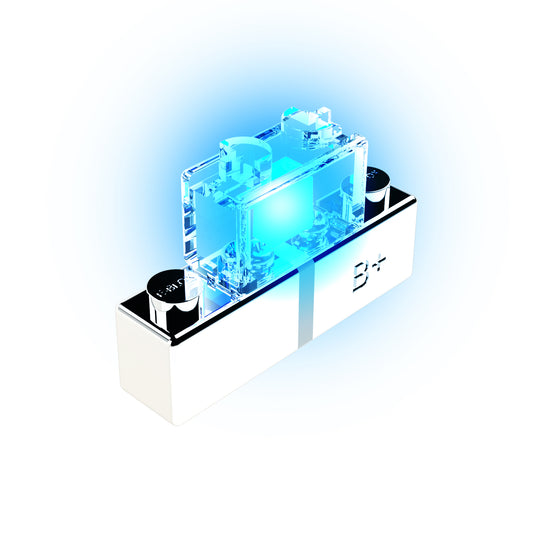 A futuristic, transparent circuit component from E-Blox, labeled "B+" and set on a sleek white base, emits a bright blue glow. The LED - Solid Color enhances the high-tech, advanced electronic design.