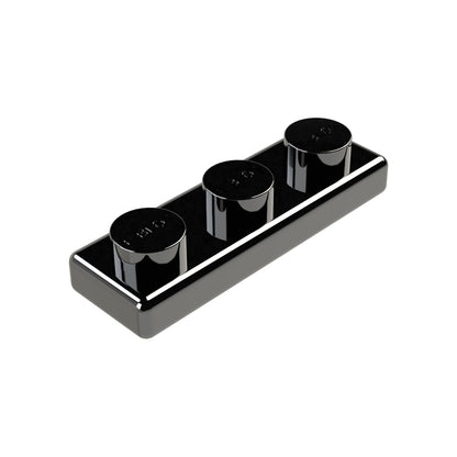 The E-Blox 1x3 Plate is a sleek, rectangular plate in black and chrome, featuring three evenly spaced round studs. This plate boasts a reflective finish and a modern, minimalist design, crafted with conductive tin for excellent performance.