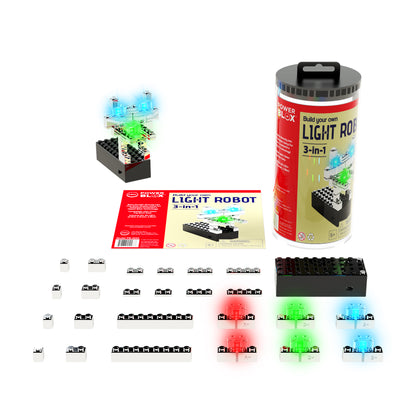 The Power Blox™ LED Light Robot Kit by E-Blox is displayed, featuring a cylindrical package, an instruction booklet, and various electronic block components in black, white, red, blue, and green to build the robot. Using patented technology to build circuits, some blocks are illuminated in green and blue.