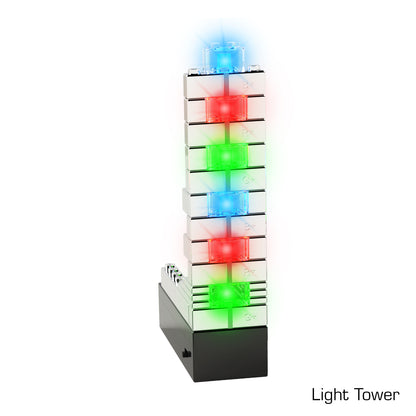 A vertical tower of seven stacked, LED-illuminated blocks from the E-Blox® Power Blox™ Starter Set on a black base. Each block emits a different color light: blue at the top, followed by alternating red and green lights. Incorporating patented technology, the text "Light Tower" is written in the lower right corner.