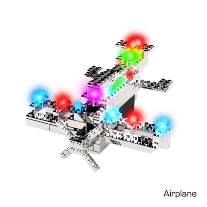 A Power Blox™ Pro Set from E-Blox® featuring vibrant LED light-up building blocks in red, green, blue, and purple hues. This stylized airplane model is constructed from shiny, reflective metallic parts and resembles a sophisticated toy brick set. It fosters creativity with the word "Airplane" elegantly written in the bottom right corner.