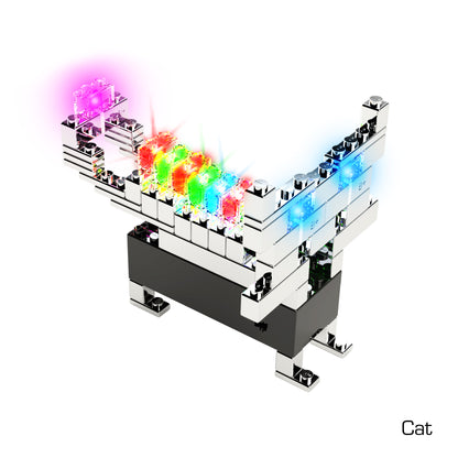 A digital artwork features a cat constructed from metallic, reflective blocks reminiscent of those in the Power Blox™ Standard Set by E-Blox®. The cat's back showcases a row of blocks emitting vibrant colors: pink, red, green, and blue. Its upright tail is adorned with a glowing pink block at the tip. The word "Cat" is inscribed in the bottom right corner.