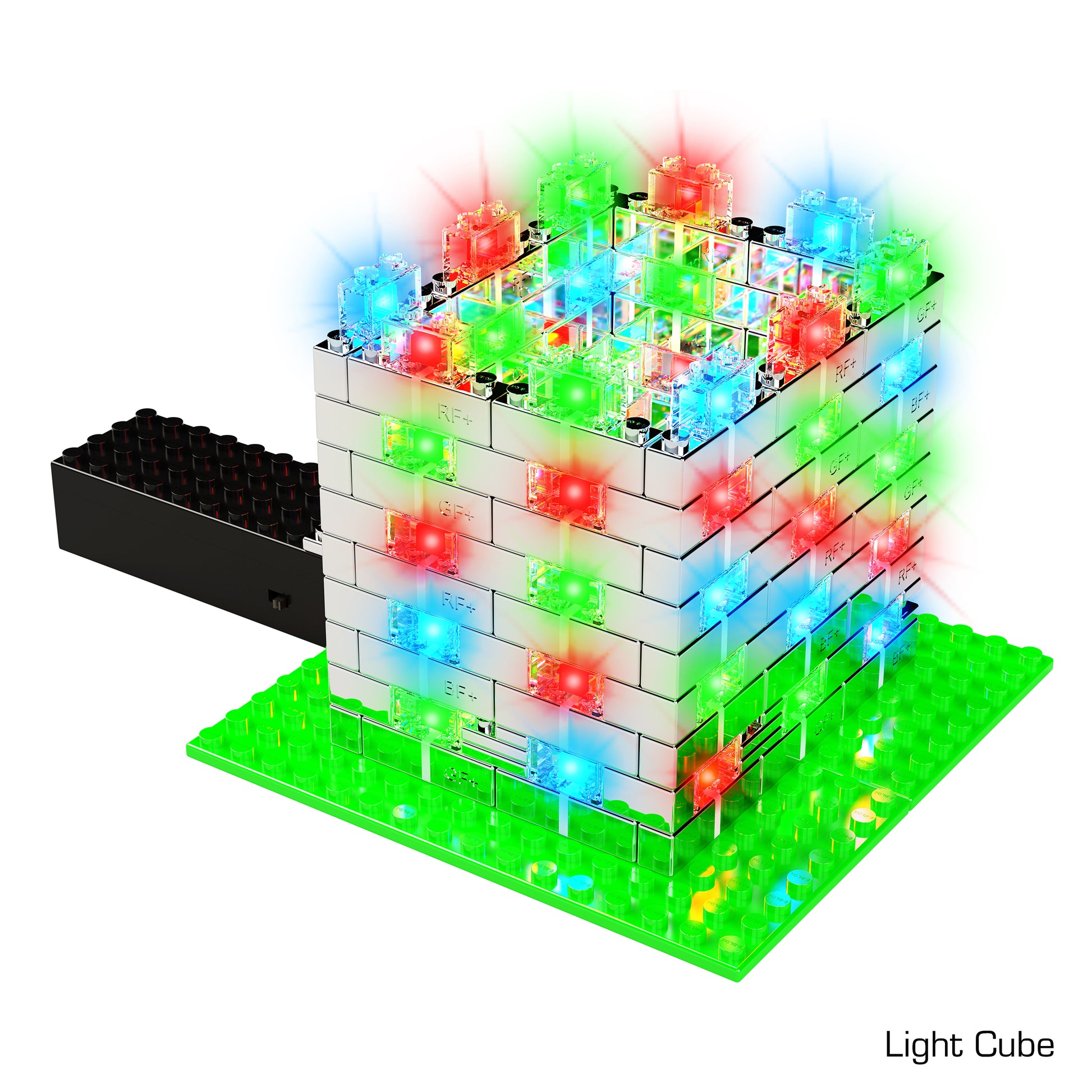 The Power Blox Flashing Frenzy by E-Blox is a cube-shaped structure made of interlocking LED Light-Up Building Blocks, featuring vibrant, multicolored lights in red, blue, and green. It is built on a bright green baseplate with an attached black component. This innovative product integrates 3D circuits to provide an engaging STEM curriculum experience.