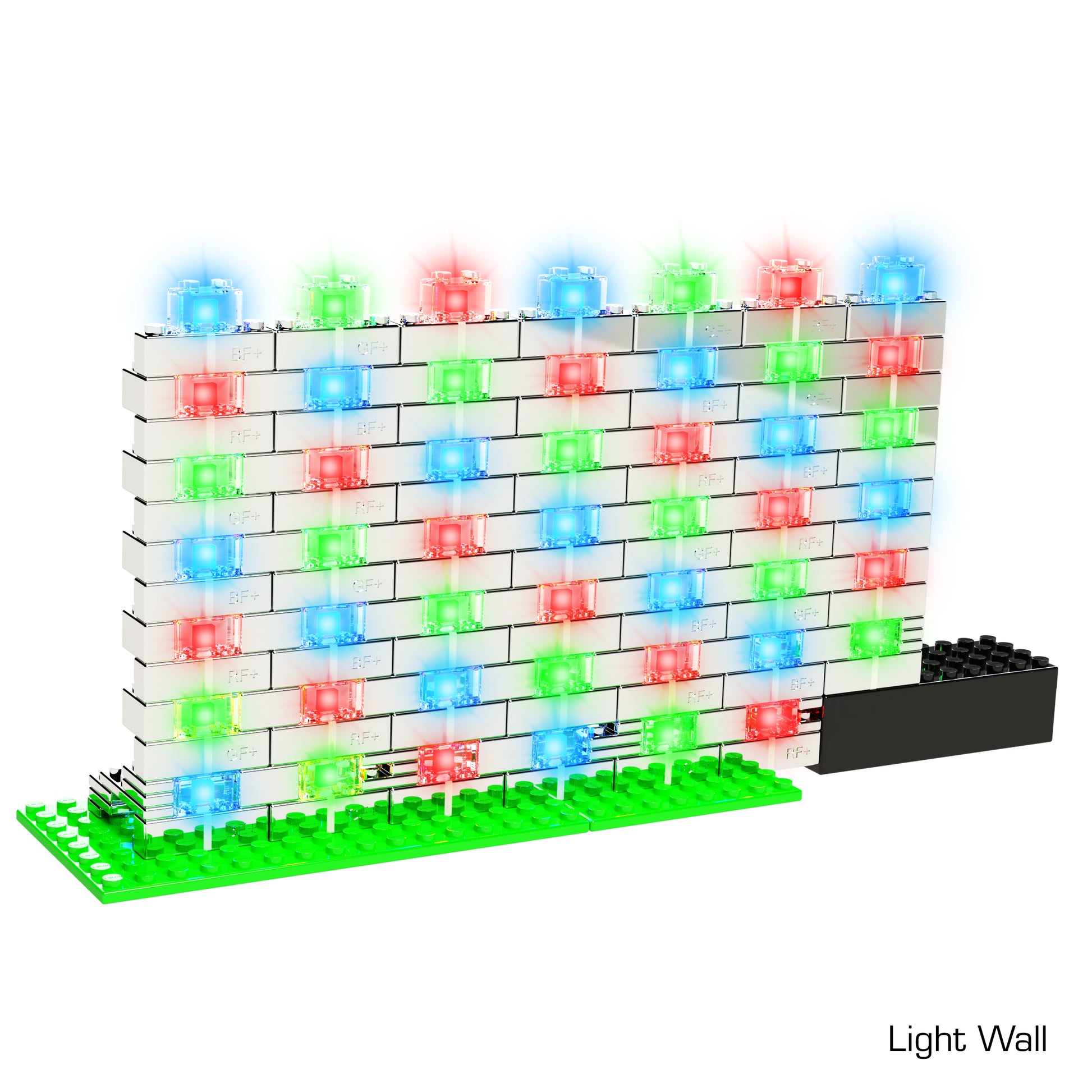 A wall constructed of interlocking white Power Blox Flashing Frenzy - E-Blox® LED light-up building blocks, featuring blue, red, and green LEDs arranged in a precise grid pattern. The base is green with a black rectangular component at the bottom right corner labeled "Light Wall." This patented technology by E-Blox can be seamlessly integrated into any STEM curriculum to teach 3D circuits.