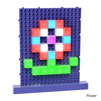 An illuminated pixelated artwork of a flower crafted with Lite Blox from E-Blox, Inc. The flower features red and white petals with a blue center. The stem is green, and the background grid is blue. Text at the bottom right corner reads "Flower.