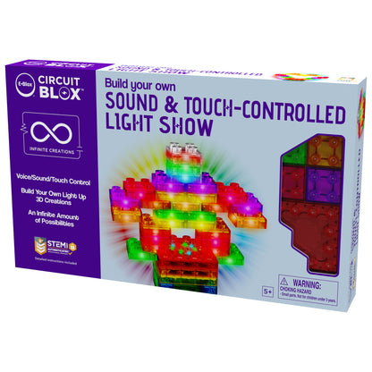 The image showcases the packaging for E-Blox's "Circuit Blox™ Sound & Touch-Controlled Light Show" kit. The box displays vibrant 3D creations constructed from LED blocks and emphasizes the voice, sound, and touch control capabilities provided by an intuitive controller module. Ideal educational play for children ages 5 and up.