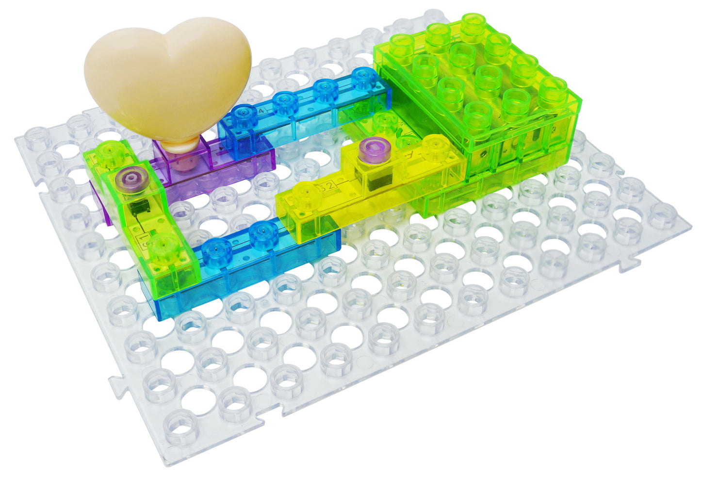 The Circuit Blox™ 59 - E-Blox® Circuit Board Building Blocks Toys by E-Blox features a transparent baseplate that holds various connected, translucent, colorful building blocks in yellow, blue, green, and purple. A cream-colored heart-shaped figure is positioned on the left side of the structure, making it an ideal centerpiece for STEM program building projects.