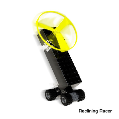 A buildable toy vehicle from the "Power Blox Build Your Own Electric Car and More!" set by E-Blox, featuring a sleek black rectangular body with a large yellow propeller on top, and four black wheels. The vehicle is tilted backward as if balancing on its rear wheels. The text "Reclining Racer" is written in the bottom right corner.