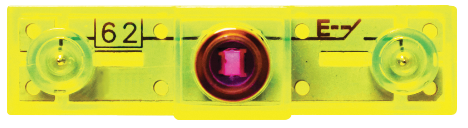 A close-up view of a translucent yellow Switch Block, a product from the E-Blox circuit builder kit, featuring two small circular elements on each side and a central purple-tinted circular element. The number "62" is visible on the left side, and a label with "F" and other letters is on the right side.