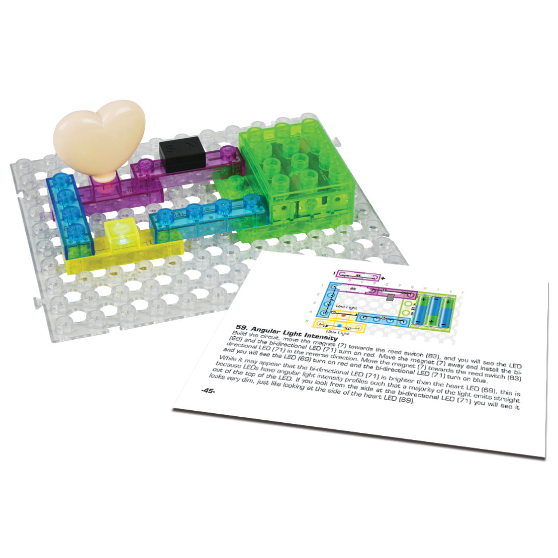 A transparent base grid holds colorful electronic components, including a heart-shaped light, connected in a Circuit Blox™ 59 project Student Set by E-Blox®. In front of it, an instruction manual is open to a page with a diagram and text, making it ideal for complementing any STEM program and meeting NGSS requirements.